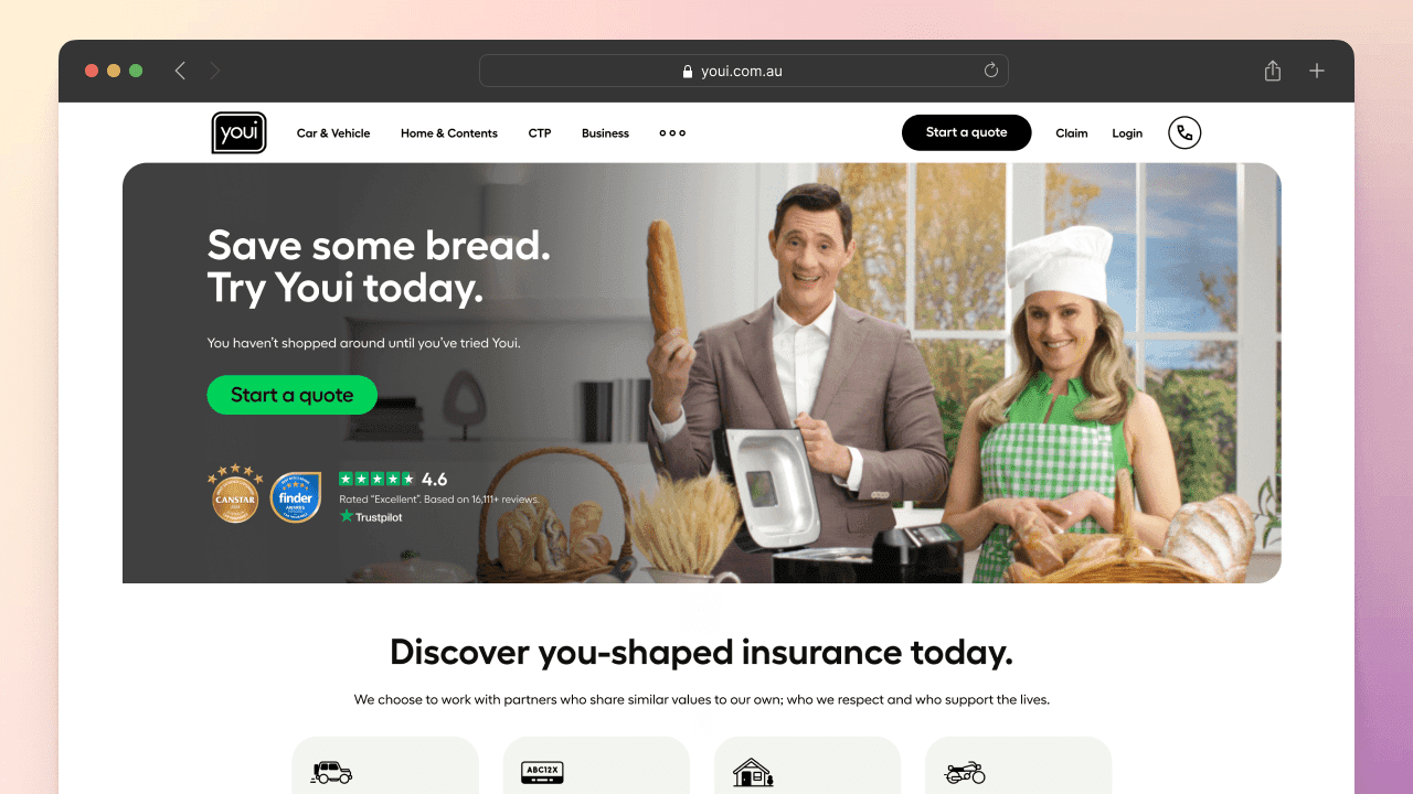 Hand holding mobile phone displaying the Youi website